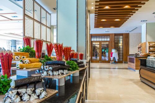 a store with red vases on display in a lobby at Kahya Resort Aqua & Spa in Konaklı