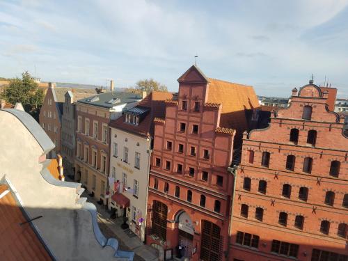 a group of buildings on a city street at Rooftop Chalet in Stralsund