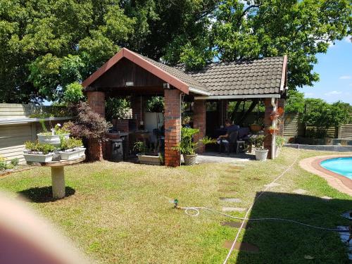 a pavilion in a yard next to a pool at Cassiandra Place unit 1 in Richards Bay
