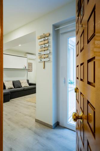 a door leading to a living room with a couch at Exclusive quietness in the heart of Madrid with Public Parking, Breakfast, 2 bathrooms in Madrid