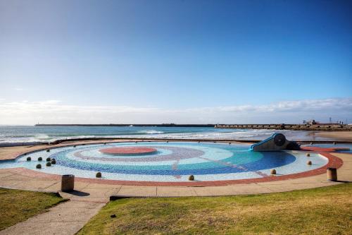 a large swimming pool next to the ocean at 14 on Marine in East London
