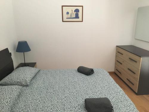 a bedroom with two twin beds and a dresser at VILLA DEGLI ULIVI in Chiavari