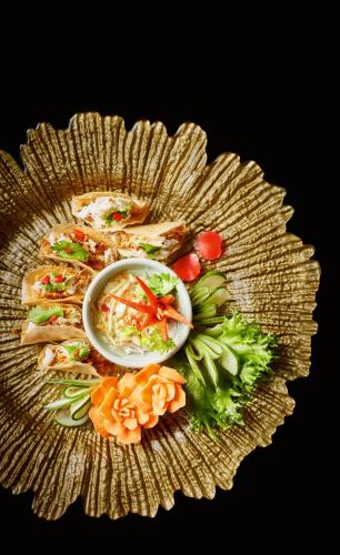 a plate of food with vegetables on a table at The Shore At Katathani - Adult Only - SHA Extra Plus in Kata Beach