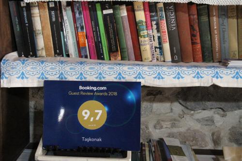 a shelf with books on it with a box on it at TAŞKONAK in Bergama