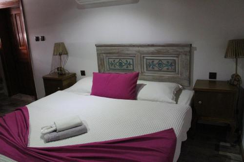 a bedroom with a large bed with two towels on it at TAŞKONAK in Bergama