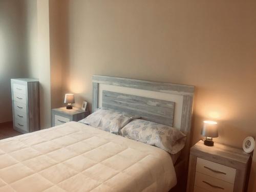 a bedroom with a large bed with two night stands at Apartament Vall d'Àger II in Ager