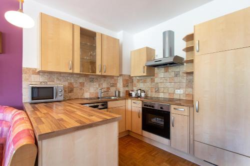 a kitchen with wooden cabinets and a counter top at Couples Getaway in Bohinj
