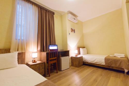 Postel nebo postele na pokoji v ubytování Hotel Tabi