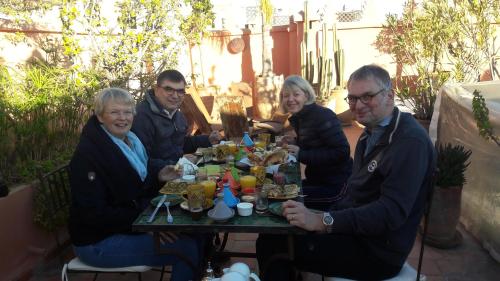 a group of people sitting around a table at Riad Les Nuits de Marrakech in Marrakech