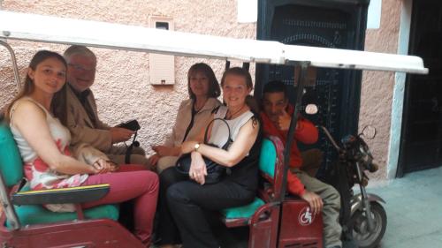 a group of people riding a golf cart at Riad Les Nuits de Marrakech in Marrakech