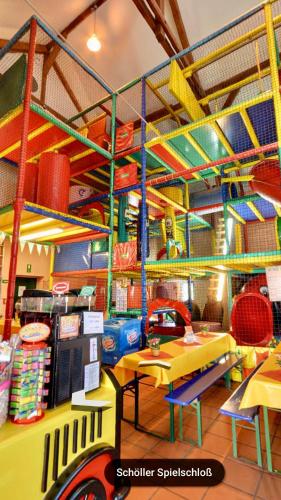 a toy store with a table and chairs and shelves at Schloss Diedersdorf in Diedersdorf