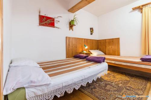 a bedroom with two beds in a room at PENSIUNEA BORDÁS PANZIÓ in Sfântu-Gheorghe