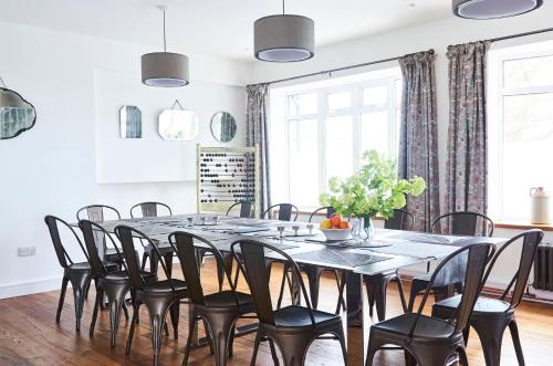a dining room with a large table and chairs at Bell Lodge in Chichester