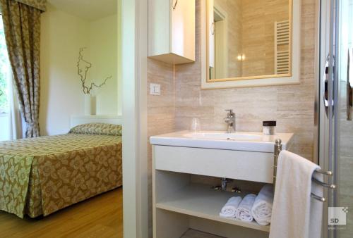 A bed or beds in a room at Locanda Dei Cinque Cerri