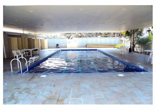 a large swimming pool with blue water in a building at Divers home in Ras al Khaimah