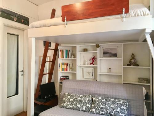 a bedroom with a bunk bed and a couch at La GEMMA del Quadrilatero in Turin