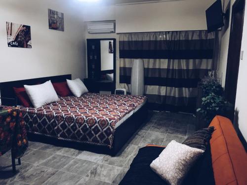 a bedroom with a bed and a couch in it at Studio in heart of Limassol in Limassol