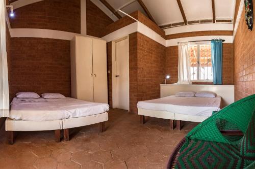 a room with two beds and a window at Sougri Doogo in Loumbila