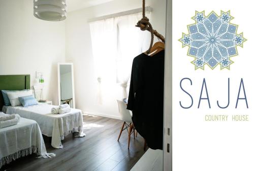 a bedroom with two beds and a room with a mirror at Saja Country House in Acireale
