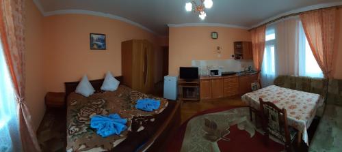 a living room with a bed with blue flowers on it at Hercules in Truskavets