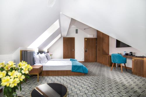 a bedroom with a bed and a desk and a staircase at Platinum Residence Boutique in Poznań
