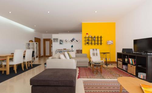 a living room with a couch and a table at Eco Apartment @ Torre Verde (Green Tower) in Lisbon