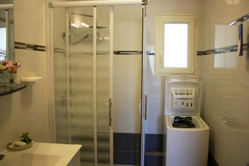 a glass shower in a bathroom with a sink at Belle maison à 600 mètres de la grande plage de Saint-Gilles-Croix-de-Vie in Saint-Gilles-Croix-de-Vie