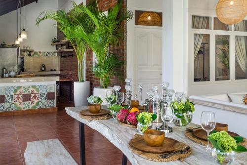 a kitchen with a table with fruits and vegetables on it at Smiling Cactus Villas - Seminyak in Seminyak