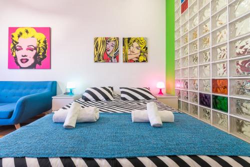 a bedroom with a bed with a blue rug at Zenios Amintas-Pop-artment for two in city center in Athens