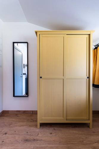 a wardrobe in a room with a mirror at Liepaja Apartments in Liepāja