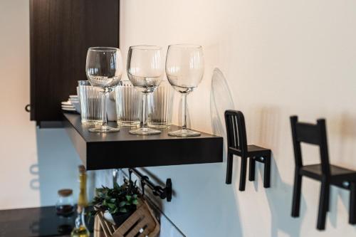 a group of wine glasses sitting on a table at Liepaja Apartments in Liepāja
