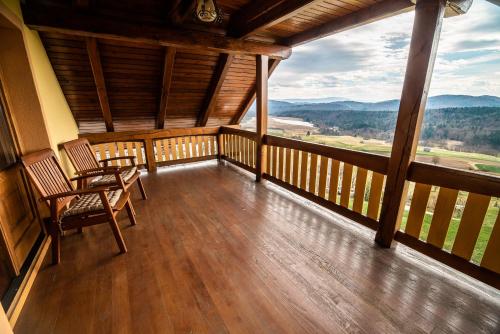 a balcony with two chairs and a view of the mountains at Holiday Home Mirt with HotTub & Sauna in Blanca