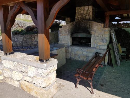 a bench sitting in front of a stone oven at Holiday Home Mirt with HotTub & Sauna in Blanca