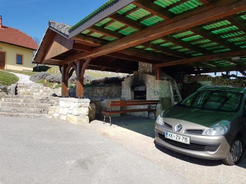 a car parked under a pavilion with a picnic table at Holiday Home Mirt with HotTub & Sauna in Blanca