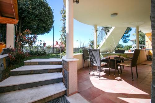 a patio with chairs and a table and stairs at Apartments Apartim Piran in Piran