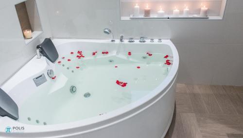 
a bathtub filled with lots of pink flowers at Polis Boutique Hotel in Naxos Chora
