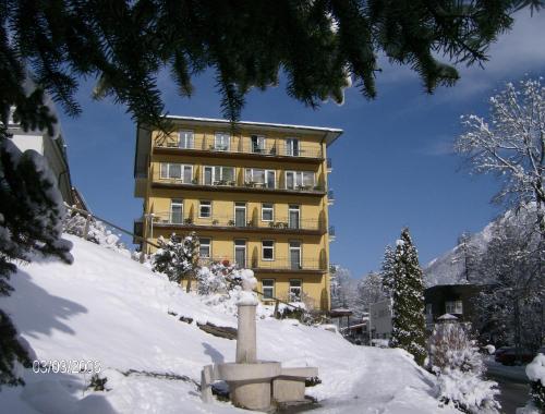 a building on top of a snow covered mountain at Kurhotel & Hotel Mozart in Bad Gastein