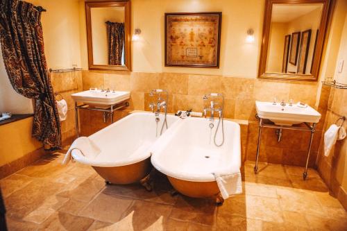 a bathroom with two sinks and a tub and two sinks at Bailiffscourt Hotel & Spa in Arundel