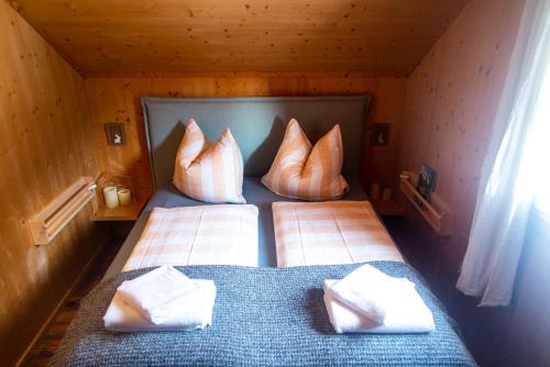 a bedroom with two beds with pillows at Chalet ?Snow Bunny? in Stadl an der Mur