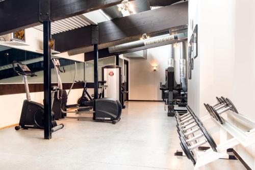 a gym with treadmills and cardio machines in it at Hankø Hotell & Spa in Gressvik