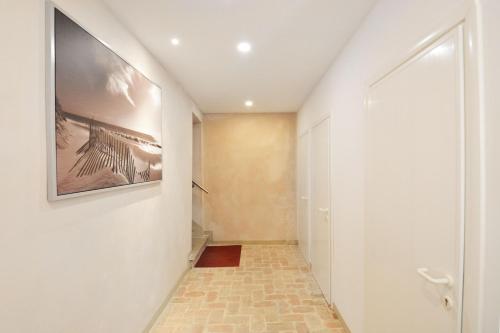 a hallway with a tile floor and a painting on the wall at Home Venice Apartments - Biennale 1 - 2 - 3 in Venice