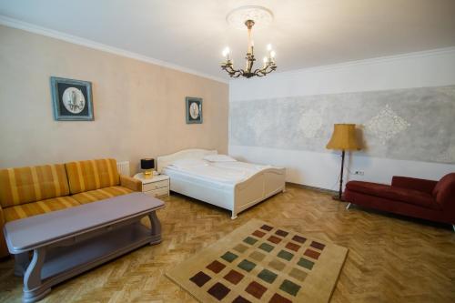a living room with a bed and a couch at Vila Sibiu in Sibiu