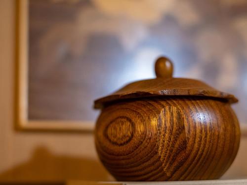 a wooden vase sitting on top of a table at Shirayunoyado Yamadaya Hakone Gora in Hakone