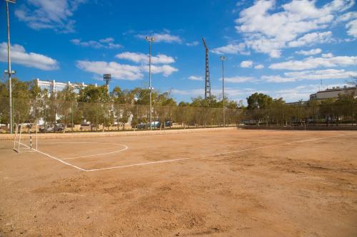 an empty tennis court with a net at Assiut Cement Hotel in Asyut