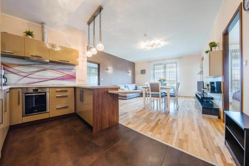 an open kitchen with a living room and dining room at Olympic Park I, Sun & Snow in Kołobrzeg