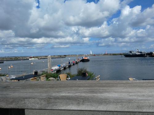 a marina with boats in the water on a cloudy day at Perle am Ijsselmeer mit eigenem Tretboot in Medemblik