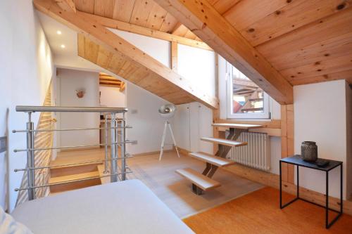 a room with a loft with wooden ceilings at Home Venice Apartments - Biennale 1 - 2 - 3 in Venice