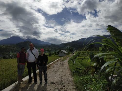 a group of people standing on a dirt road at De Salak Homestay in Bogor