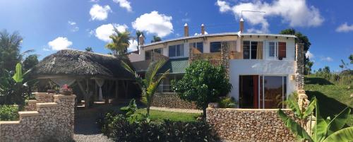 a large house with a thatched roof at Cabrera Chalet boutique hotel in Cabrera