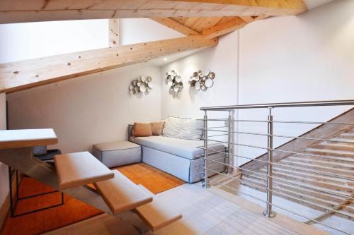 a living room with a couch and a staircase at Home Venice Apartments - Biennale 1 - 2 - 3 in Venice